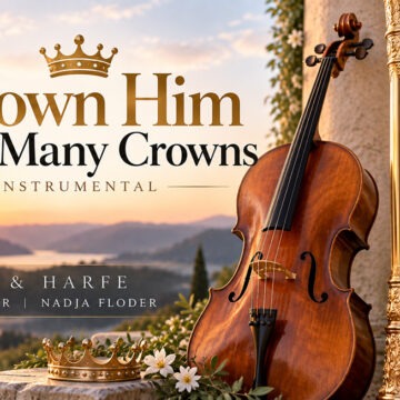 crown Thumbnail for “Crown Him with Many Crowns,” featuring a cello and harp set against a warm mountain and lake landscape at sunset. Two golden crowns symbolize the title of this sacred instrumental piece by Corina Floder and Nadja Floder.